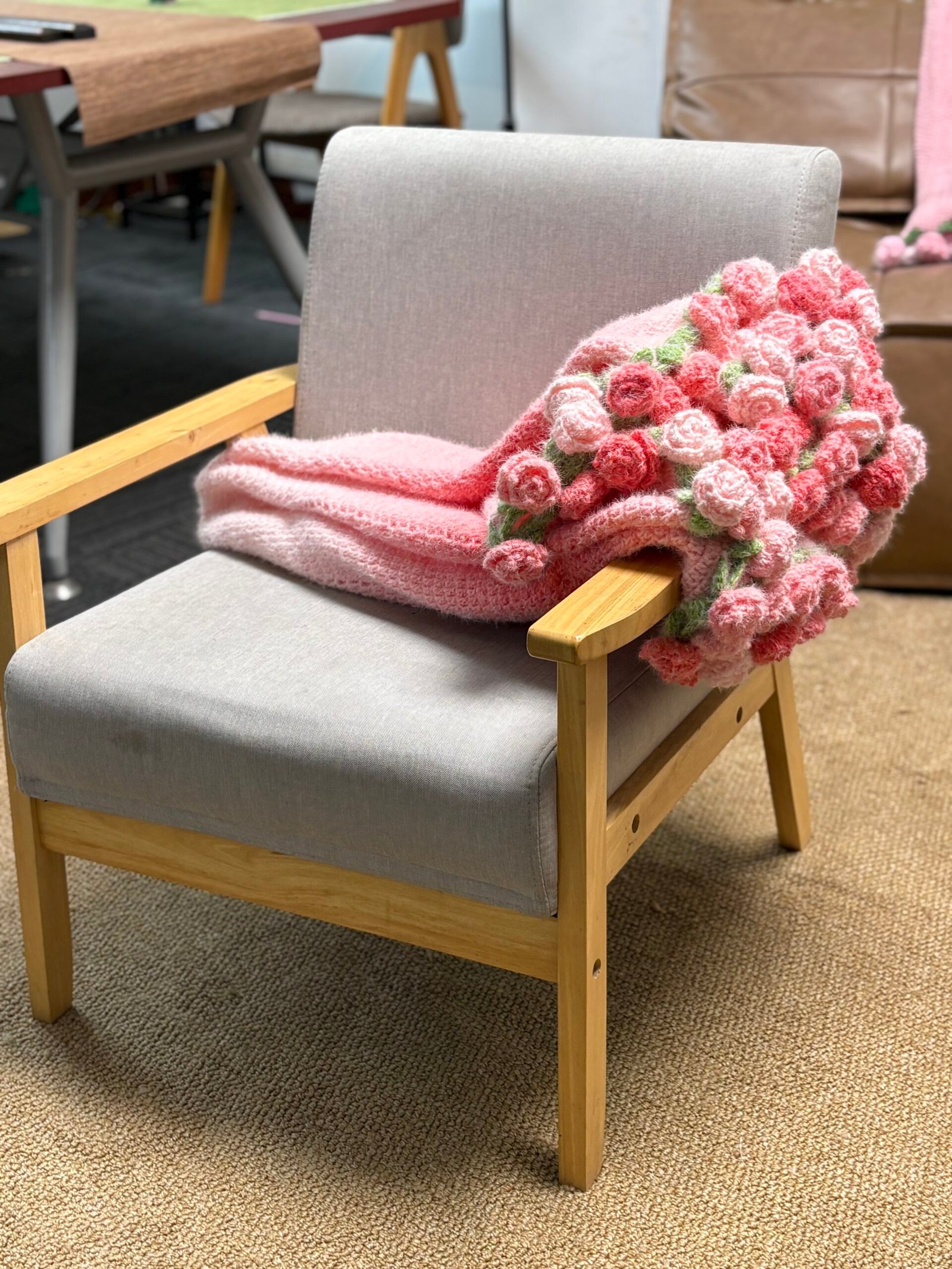 The flower bouquet blanket folded on a chair