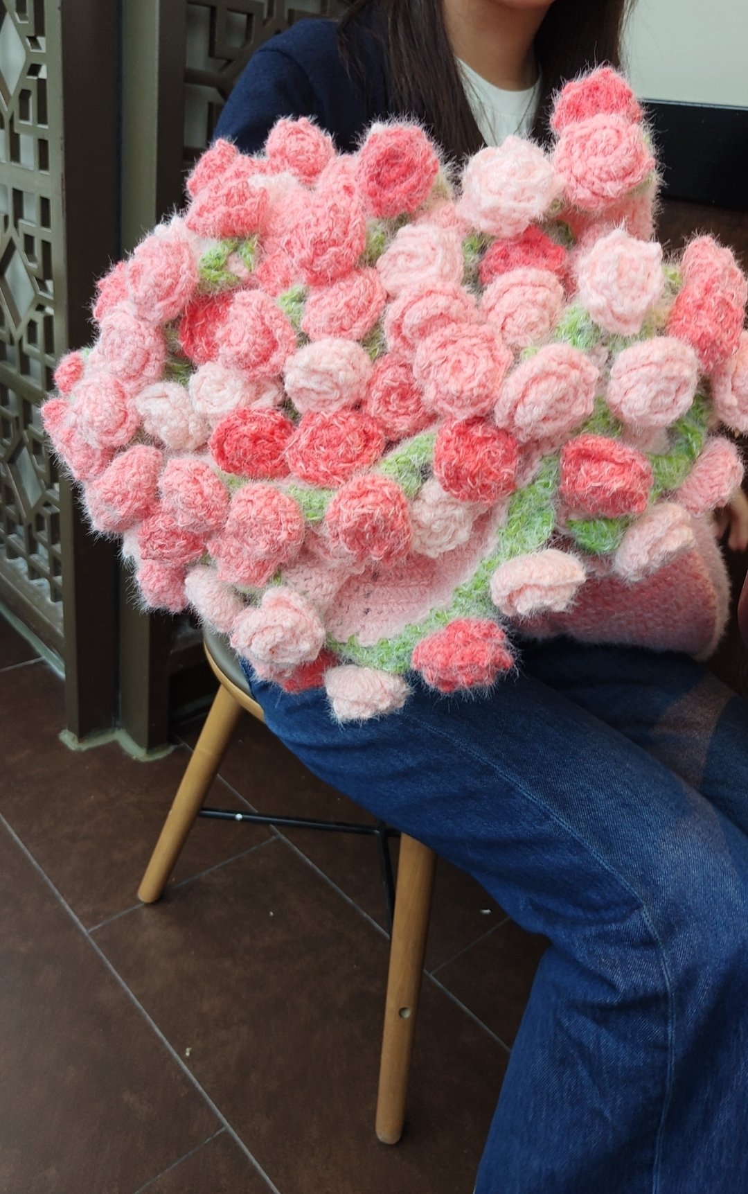 A person holding the handmade flower bouquet blanket